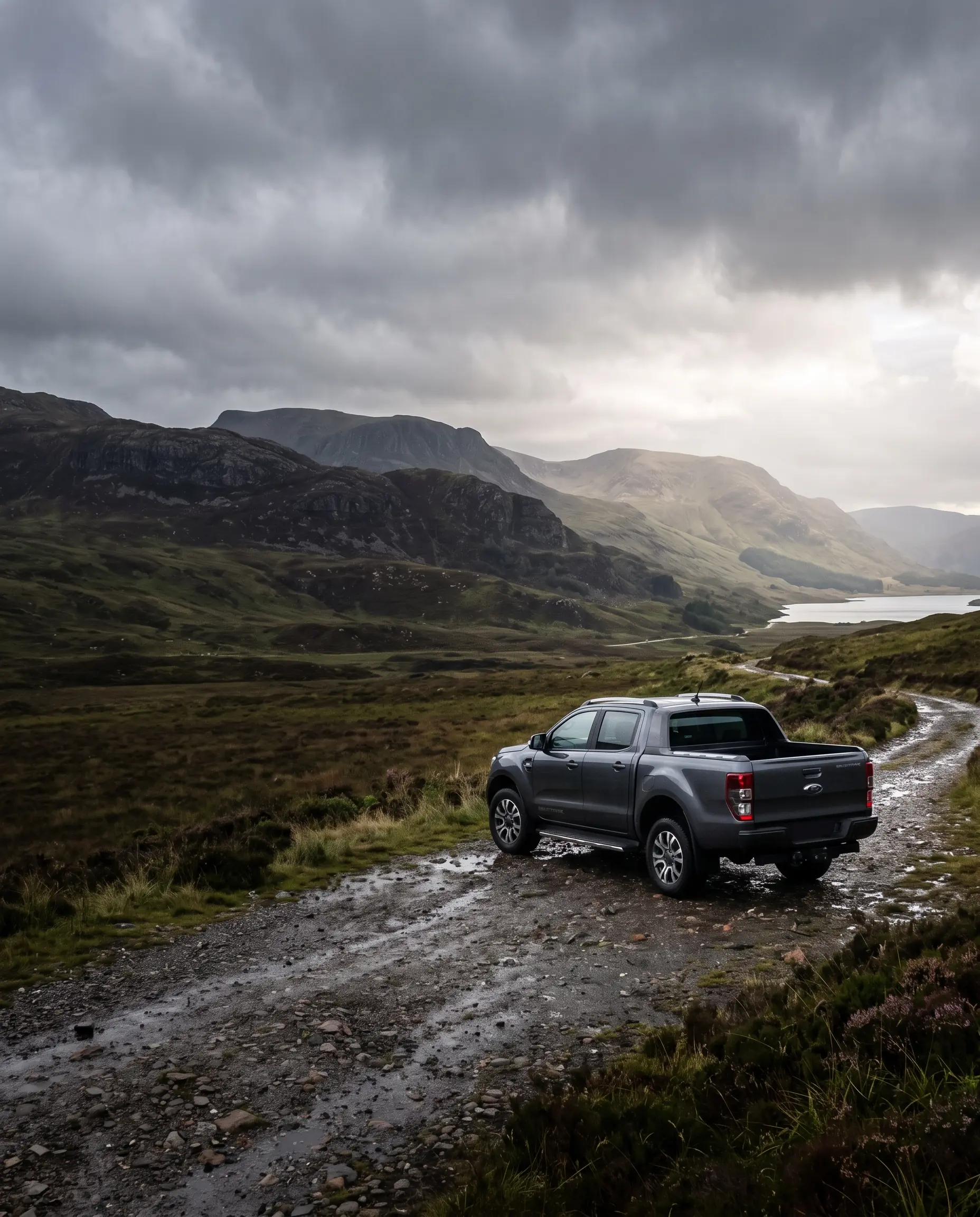 Adventra commercial pickup on a single-track Highland road under heavy cloud